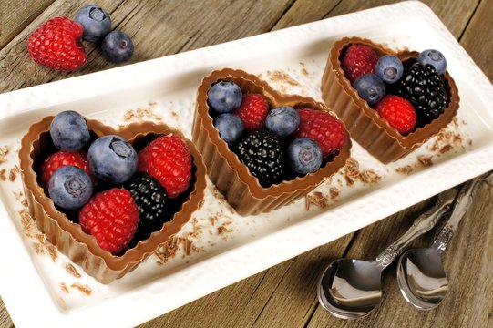 Plate of chocolate heart dessert cups with fruit