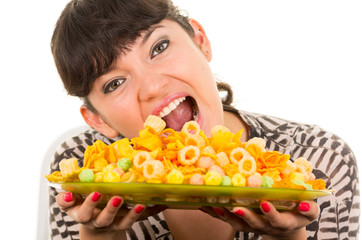 young beautiful girl eating junk food chips