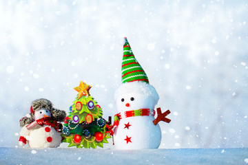 two snowmen standing in the snow