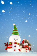 two snowmen standing in the snow