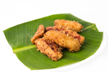 Banana fritters or fried banana served on banana leaf