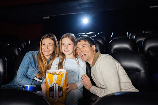 Cheerful Family Enjoying Film In Theater