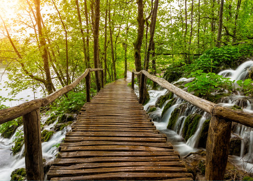 Pathway and stream with crystal clear water in Plitvice