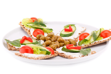 Cracker with fresh vegetables and cream