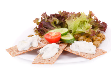 Cracker with fresh vegetables and cream