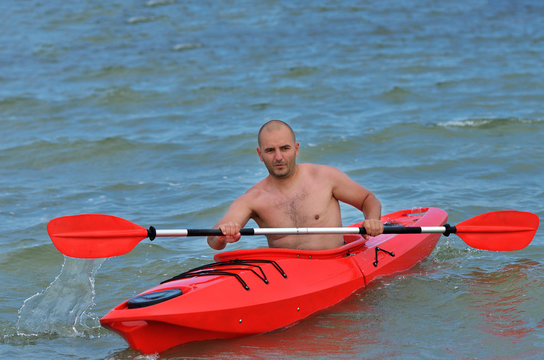 Young Caucasian Man Kayaking In Black Sea