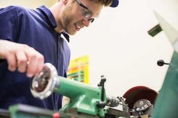 Engineering student using heavy machinery
