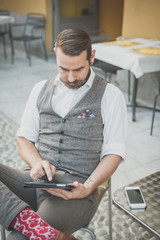 handsome big moustache hipster man using tablet