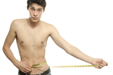 Skinny young man posing fashion with a centimeter, anorexic look