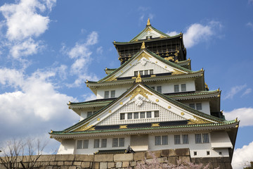 Fototapeta premium Osaka Castle in Japan during cherry blossom season in spring.