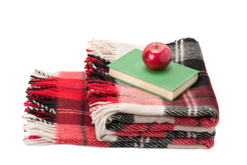 blanket and a book with an apple isolated on white background