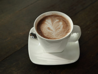 Hot chocolate in a white cup on table