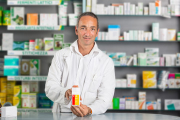 Handsome Pharmacist at Work in a Drugstore