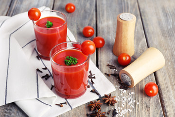 Tomato juice in glasses and fresh vegetables