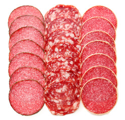 Slices of salami isolated on white