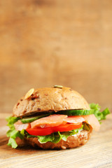 Sandwich with salmon on wooden background