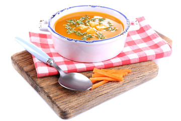 Carrot soup on cutting board isolated on white