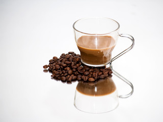 Coffee cup and coffee beans on a mirror