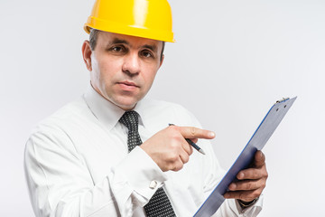 Mature contractor with hardhat and clipboard