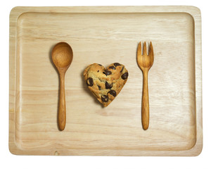 Heart cookie with chocolate chips on wood tray isolated