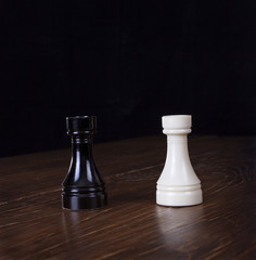 White and black chess rook on wood tabel.