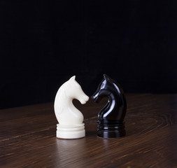 White and black chess horse on wood tabel.
