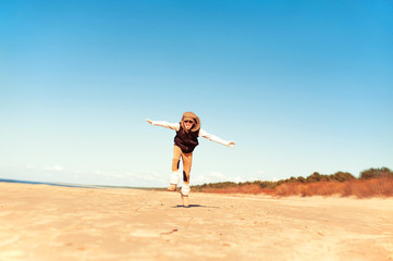 Obraz premium I believe i can fly. Happy active emotional girl jumping for joy