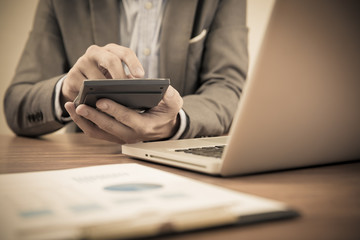 Businessman analyzing investment charts with laptop. Accounting