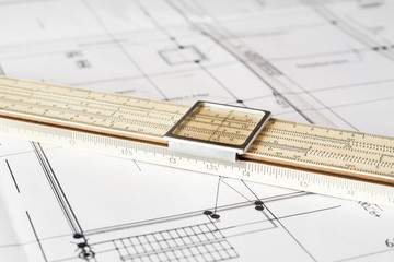 Schemes and slide rule on the table. Angle view