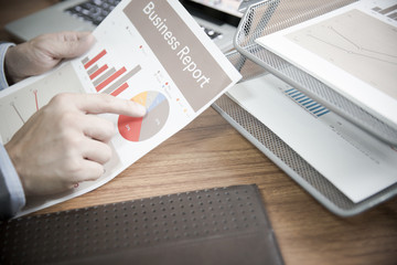 Fototapeta na wymiar Businessman analyzing investment charts with laptop. Accounting