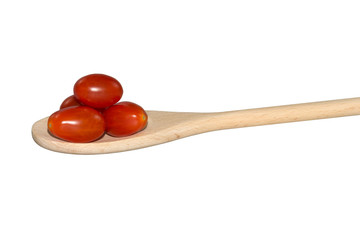 Grape tomatoes on a light wooden spoon