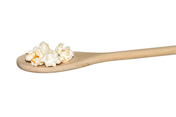 Fototapeta na wymiar Popcorn on a light wooden spoon