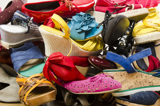 Close up on big pile of colorful woman shoes.