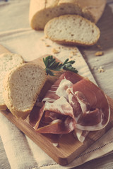 Bread and Ham Slices on a Cutting Board