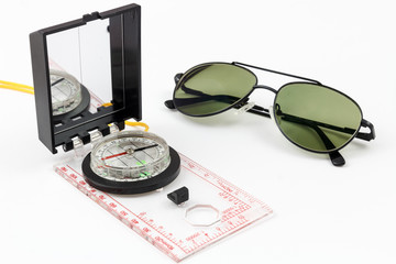 Compass and pilot sunglasses with white background