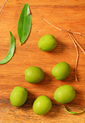 Green olives on wooden background