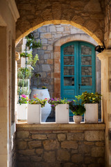 Fototapeta na wymiar Greek flowerpots with flowers