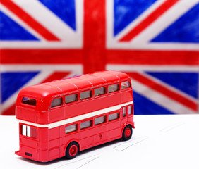 a red double Decker bus and flag