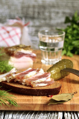 Sandwich with salted lard and glass of vodka