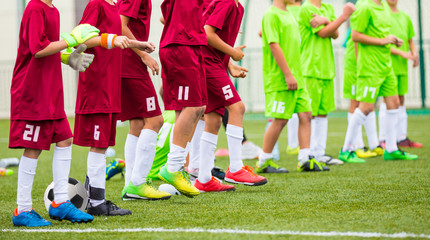 Fototapeta premium Football match on a soccer tournament. Children stand in a row