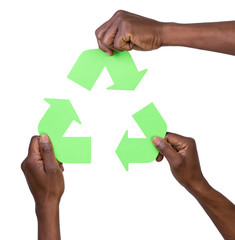 Hand holding green recycling arrows symbol