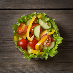 Fresh salad on wooden table