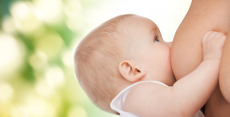 close up of mother breast feeding adorable baby