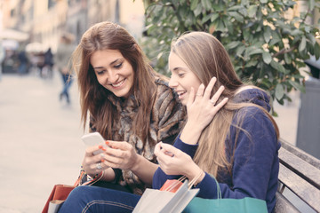 Happy Women with Smart Phone and Shopping Bags