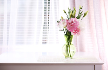 Fototapeta premium Beautiful flowers in vase with light from window