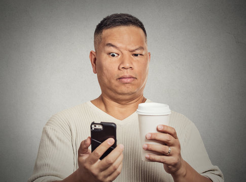 worried surprised man reading bad news sms on smartphone