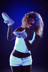 Curly model in warm gloves under UV light