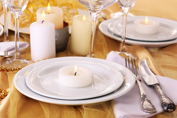 Beautiful holiday table setting in white and gold color