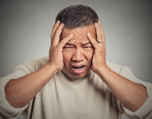 Fototapeta premium upset stressed out sick tired middle aged man having headache