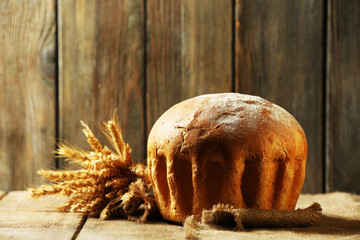 Tasty bread on table on wooden background